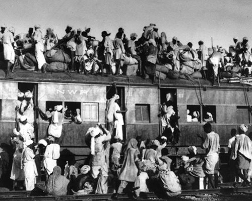 Muslim refugees sit on the roof of an overcrowded coach of a train trying to flee India near New Delhi, Sept. 19, 1947.